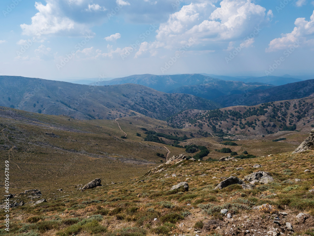 Mountain landscape in Gennargentu, highest mountain in Sardinia, Nuoro, Italy. Vaste peaks, dry plains and valleys with mediterranean vegetation. Late summer, blue sky