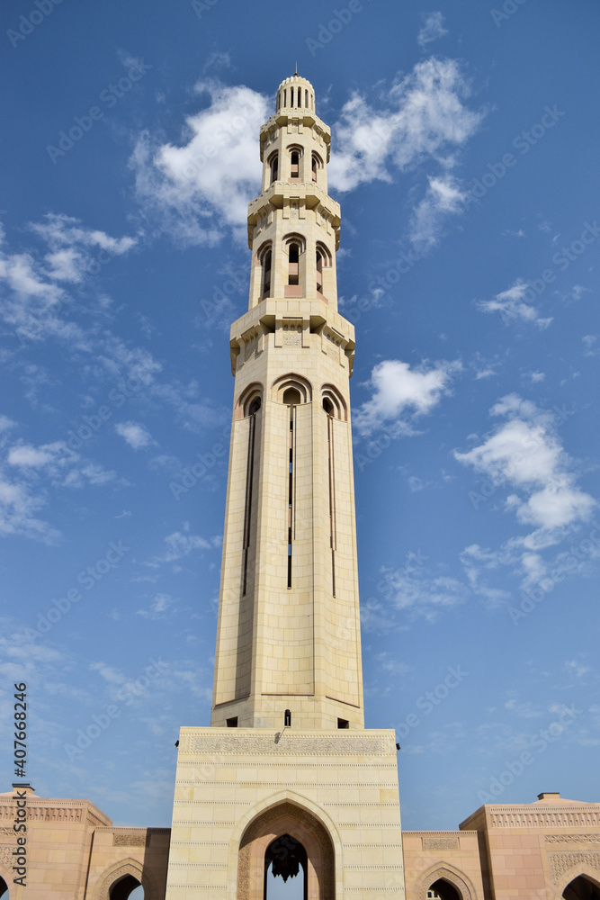 A minaret in Sultan Qaboos Grand Mosque in contrast with the blue sky. Muscat, Oman.