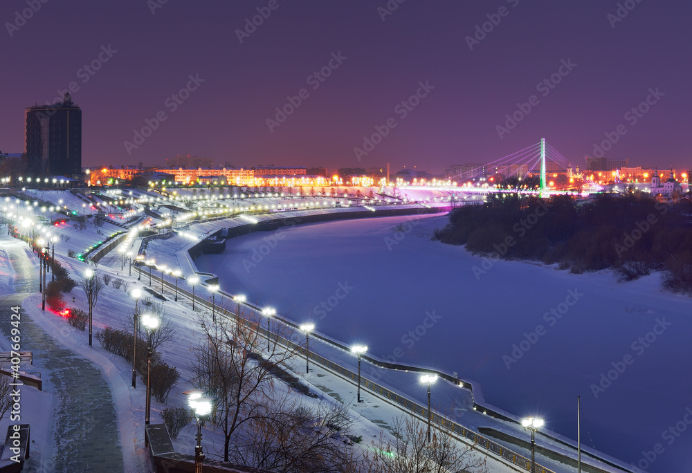 Winter evening in Tyumen. High embankment of the Tura River in the night lights