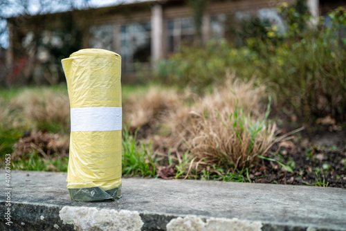 New roll of yellow sacks for recycling products on a wall