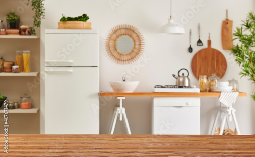 Close up wooden table and decorative kitchen background style. Refrigerator, dishwasher and stove style with lamp concept. © UnitedPhotoStudio