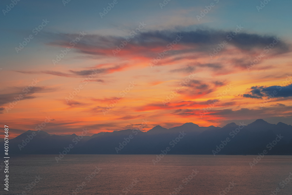 Beautiful golden sunset over the sea and mountains in Antalya, Turkey