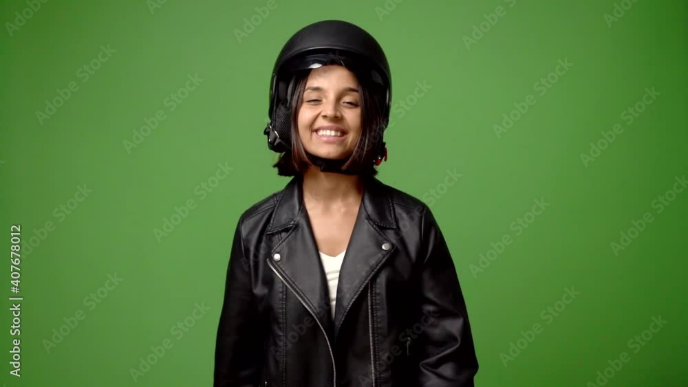 Womanm holding a motorcycle helmet showing ok sign with fingers Womanm holding a motorcycle helmet showing ok sign with fingers