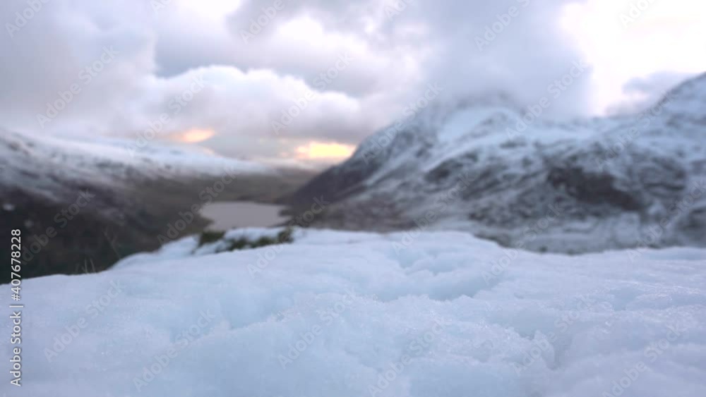 The boots of a person with crampons walking on snow The boots of a person with crampons walking on snow