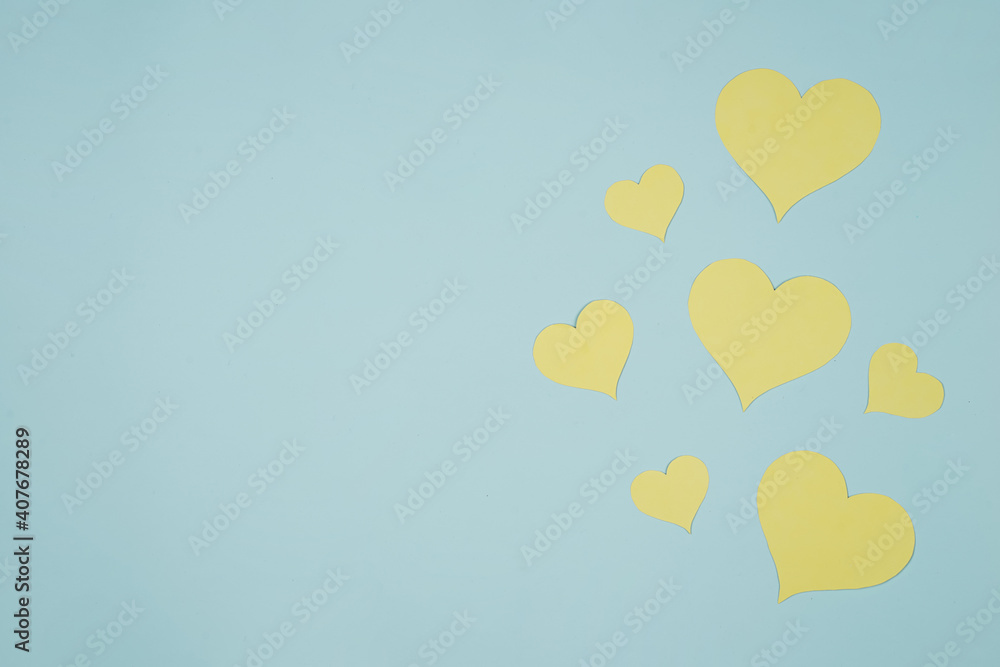 Heart shaped paper sticked on blue background. Emblem of love for happy women, beloved mother, birthday cards and valentine greeting designs. Valentine's day backgrounds. Templates to convey our love.