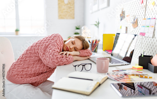 Tired freelancer sleeping during work at home photo