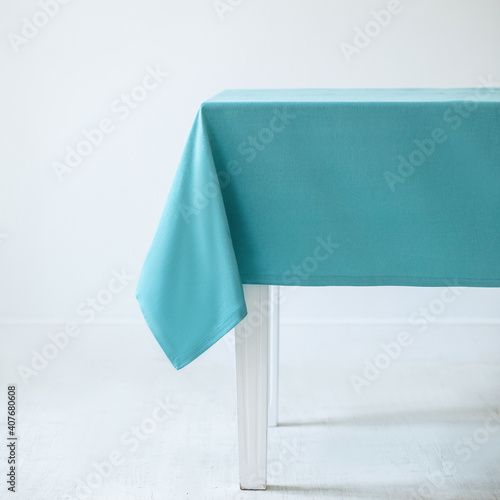 Blue decorative tablecloth on a table on a white background photo