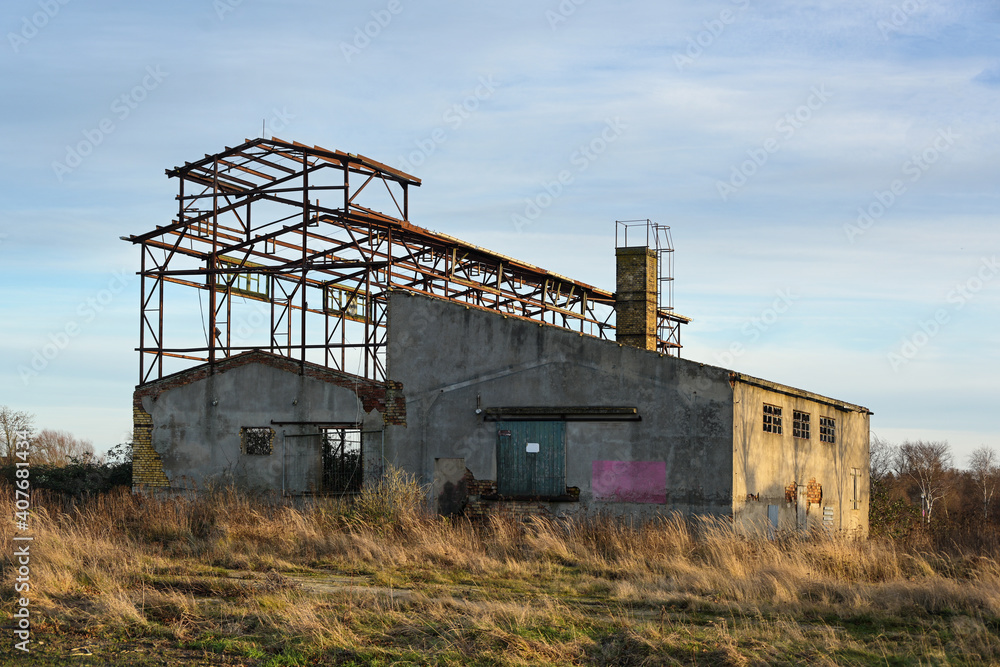Ruin of an agricultural building of a LPG (Agricultural Production Cooperative) in former East Germany from the time of the GDR (German Democratic Republic), copy space, selected focus Ruin of an agricultural building of a LPG (Agricultural Production Cooperative) in former East Germany from the time of the GDR (German Democratic Republic), copy space, selected focus