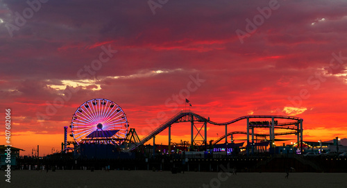 Beautiful and colorful sunset at Santa Monica, with the Pacific Park Amusement Park silhouetted in the foreground..