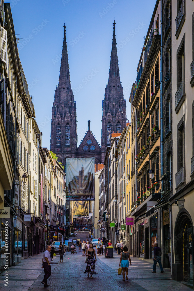 vibrant citylife in the rue des Gras with a view on the facade of the gothic cathedral of Clermont-Ferrand, in Auvergne, France