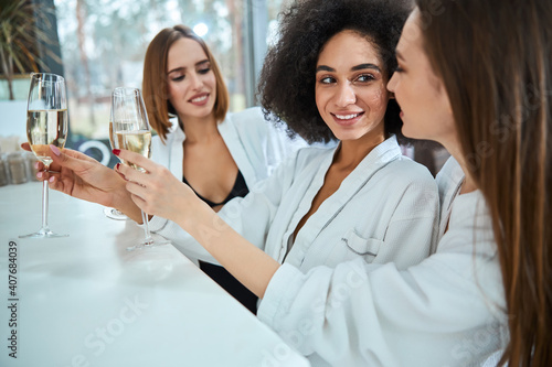 Happy young women standing and holding champagne © Viacheslav Yakobchuk