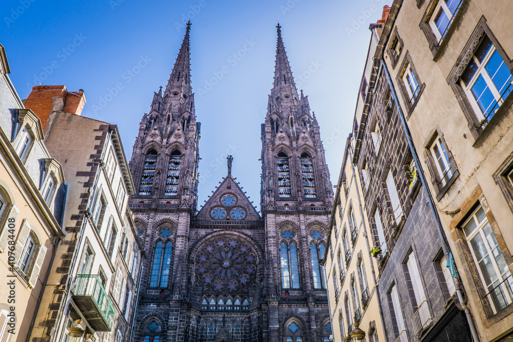 View, from the rue des Gras, on the facade of the gothic cathedral of Clermont-Ferrand, in Auvergne, France View, from the rue des Gras, on the facade of the gothic cathedral of Clermont-Ferrand, in Auvergne, France