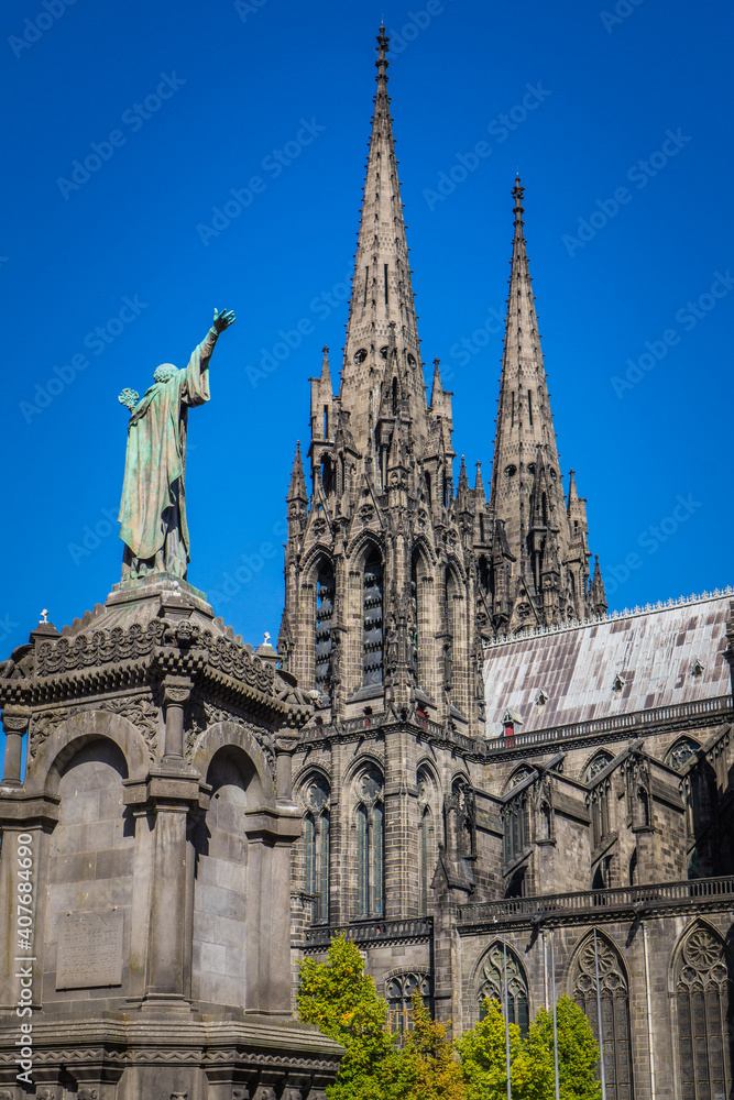 View on the gothic cathedral and the statue of Pope Urbain the 2nd from the Victory square in Clermont Ferrand, Auvergne (France)