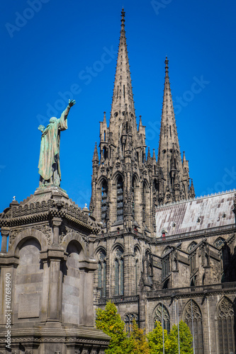 View on the gothic cathedral and the statue of Pope Urbain the 2nd from the Victory square in Clermont Ferrand, Auvergne (France)