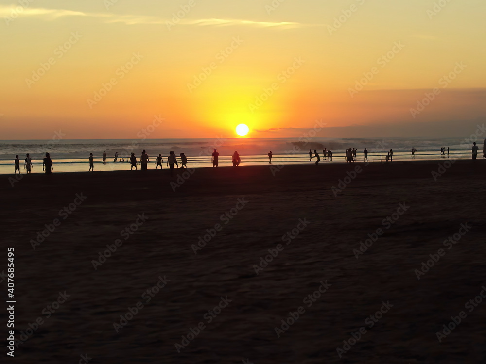 on the kuta beach at sunset