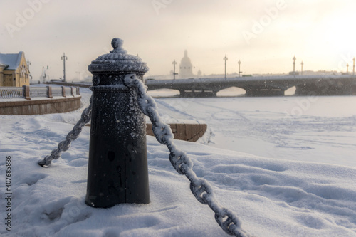 Chain Link Fence and Annunciation Bridge in St. Petersburg in winter photo