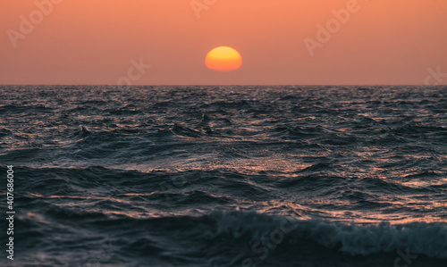 Orange sunset over the sea water surface