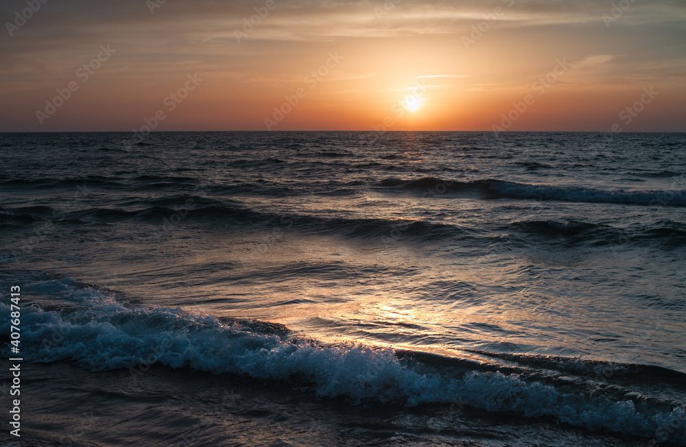 Sunset over the Mediterranean sea, waves