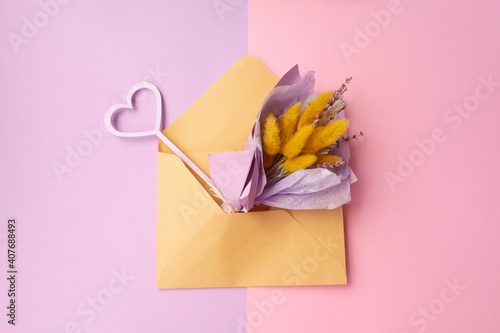 flowers bouquet in pastel colors in an envelope. Greeting card template with copy space.Mother's day, Valentine's day, birthday, spring, summer concept. Flat lay