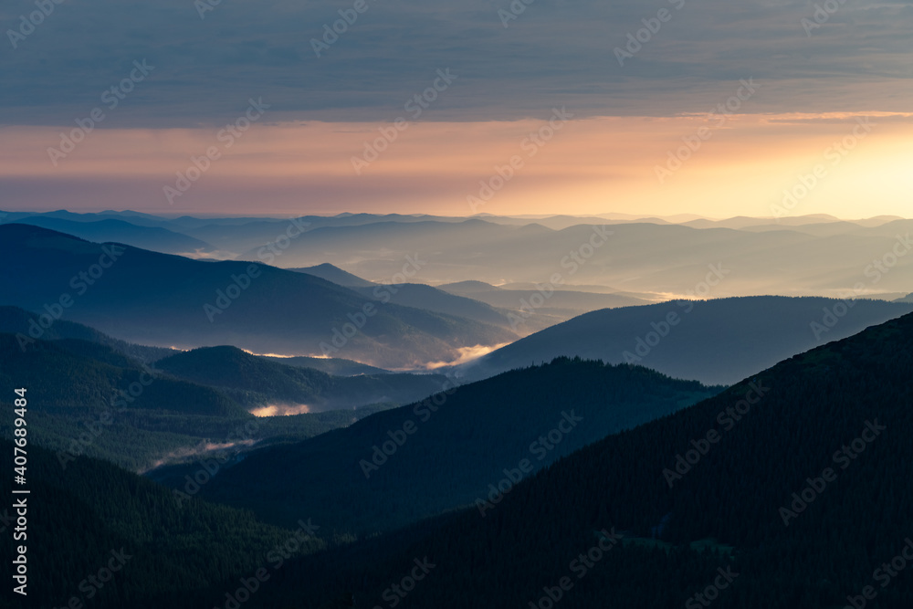 Morning fog in spring mountains. Beautiful sunrise on background. Landscape photography