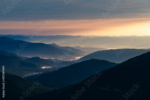 Morning fog in spring mountains. Beautiful sunrise on background. Landscape photography © Ivan Kmit
