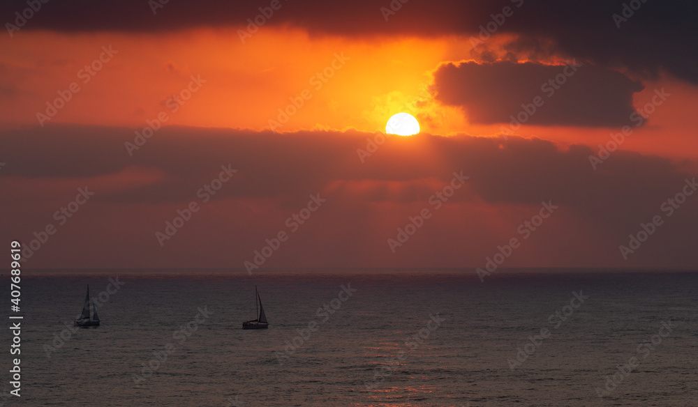 Sailboats go on the water surface during sunset. Seascape Sailboats go on the water surface during sunset. Seascape
