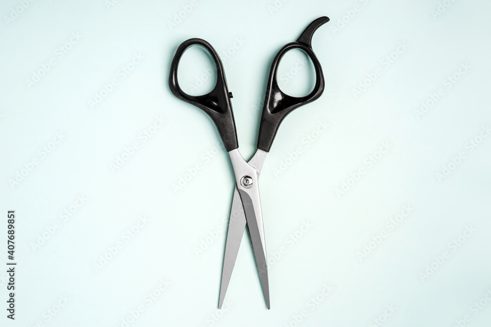 Hairdressing tools scissors lie on a blue background Hairdressing tools scissors lie on a blue background