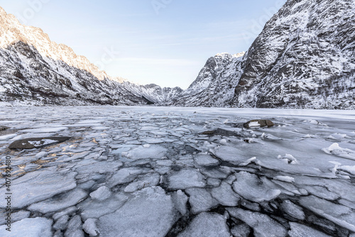 Winter landscape on a lake during Lofoten islands winter. Snow and ice melting