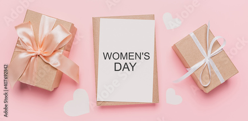 Gifts with note letter on isolated pink background, love and valentine concept with text Womens Day © Daria Lukoiko