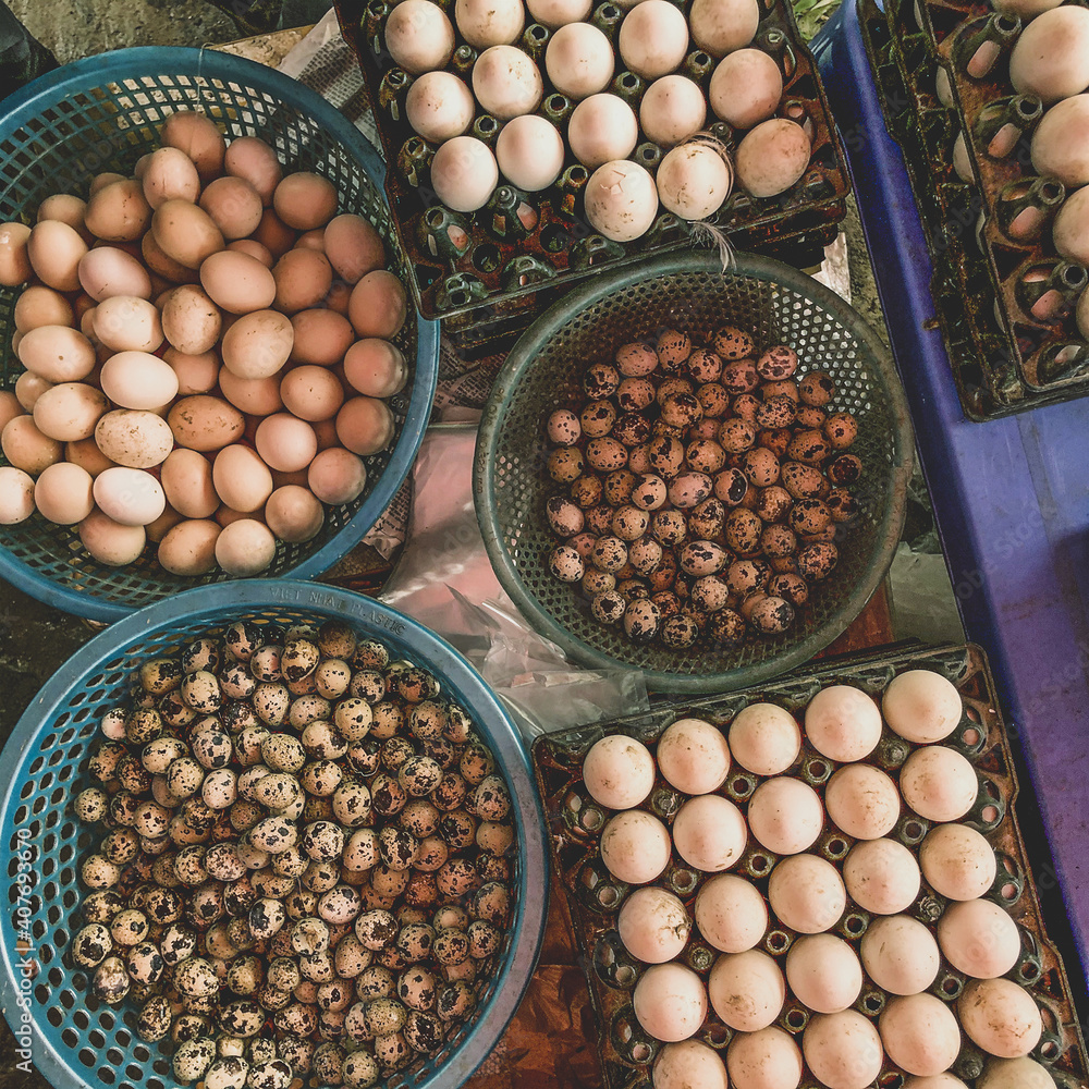 Top view on a assortment of loose eggs on a market, short circuit production Top view on a assortment of loose eggs on a market, short circuit production