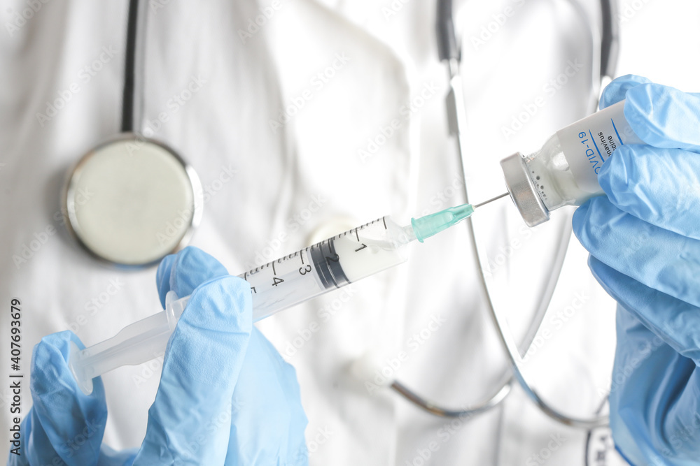 Scientist or medical worker holds Corona virus vaccine bottle.Vaccination, immunization, treatment to cure Covid 19 infection. Healthcare And Medical concept Scientist or medical worker holds Corona virus vaccine bottle.Vaccination, immunization, treatment to cure Covid 19 infection. Healthcare And Medical concept
