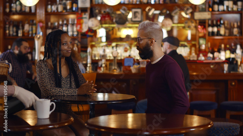Multiethnic young couple meeting in modern bar