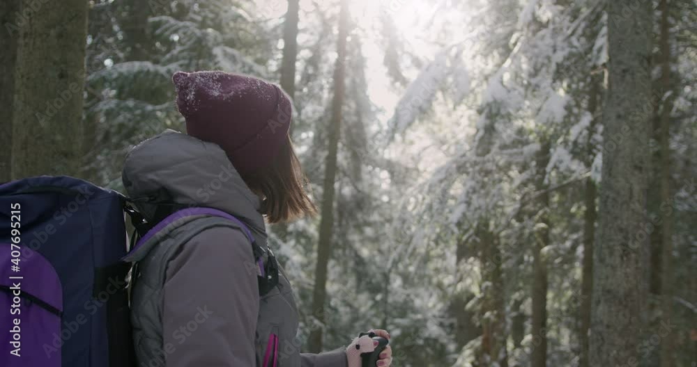 Close-up view of a woman tourist hiking in winter forest, enjoying amazing scenery. Female hiker walking in snowy mountains, breathing fresh air. Close-up view of a woman tourist hiking in winter forest, enjoying amazing scenery. Female hiker walking in snowy mountains, breathing fresh air.