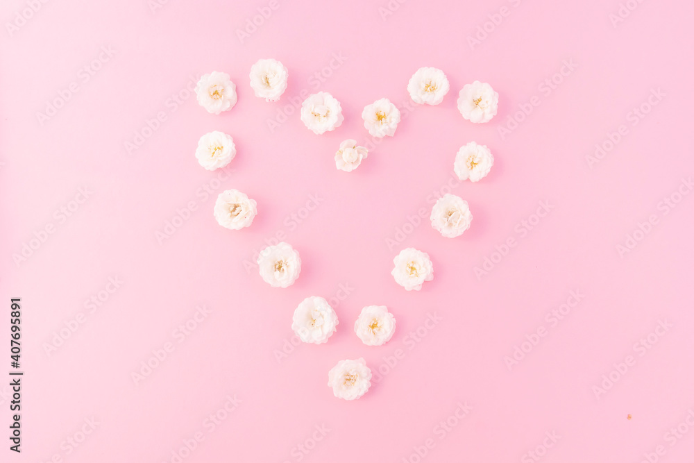 Flowers composition. heart frame made of white small rose on pink background. Mother's day, Valentine's day, birthday, spring, summer concept. Flat lay, top view