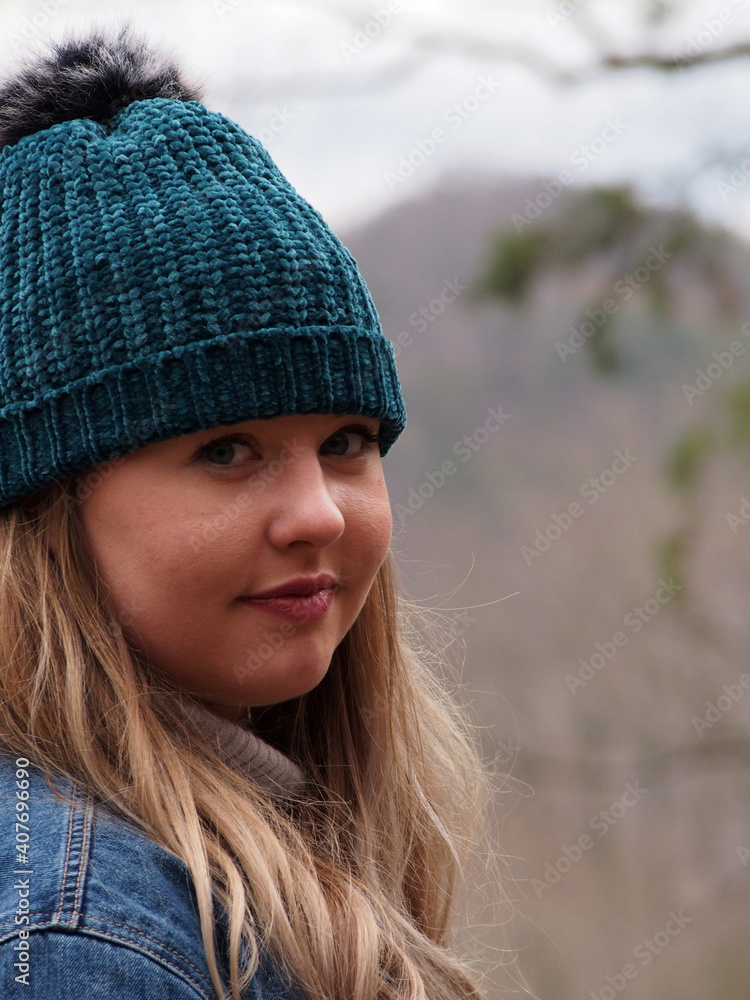 portrait of a woman in winter wearing hat and smiling portrait of a woman in winter wearing hat and smiling
