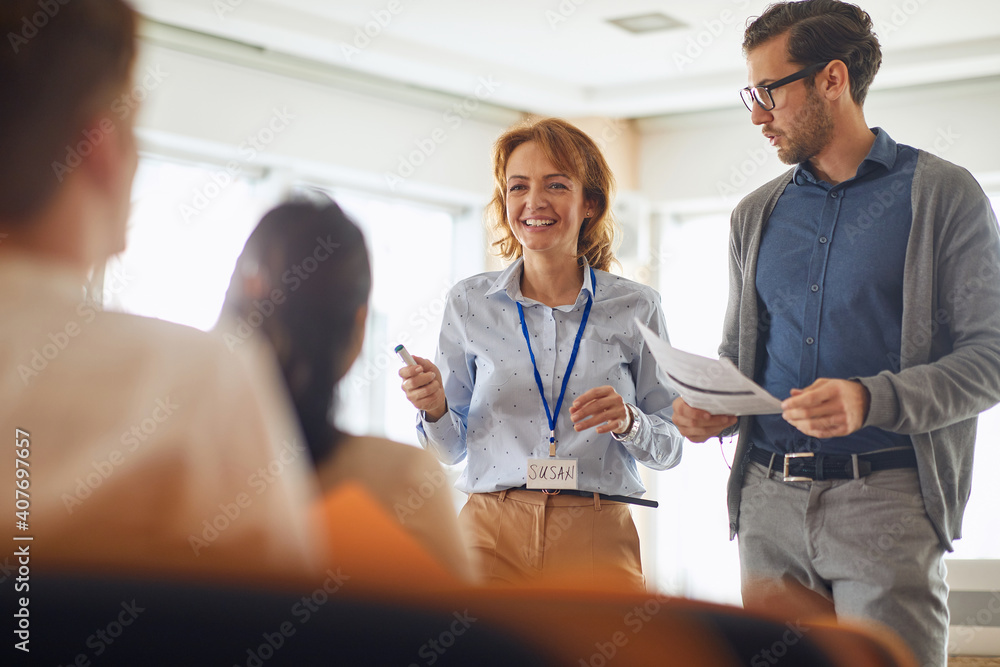 caucasian female lecturer standing with beardy male wearing glasses caucasian female lecturer standing with beardy male wearing glasses