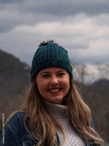 portrait of a woman in winter wearing hat and smiling