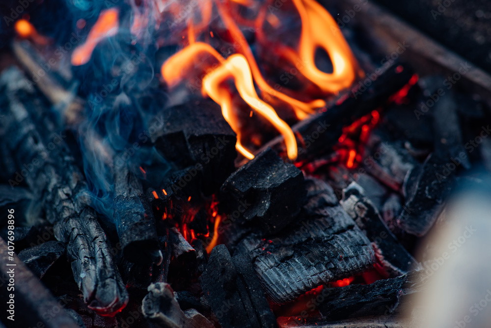 Burning campfire with beautiful flames and charcoal Burning campfire with beautiful flames and charcoal