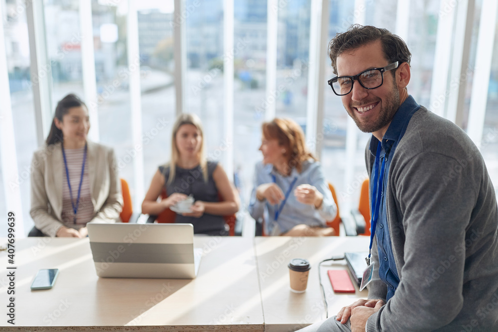portrait of young caucasian manager at business meeting. eye contact, looking at camera