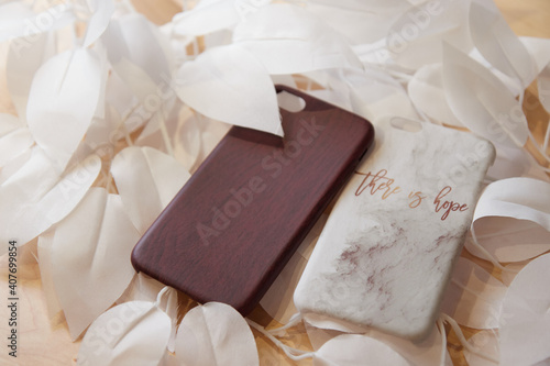 beautiful women's mobile phone cases on the table in flowers lie