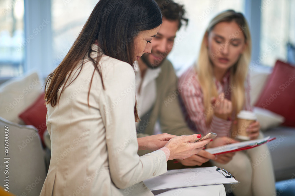Group of three colleagues consulting together Group of three colleagues consulting together