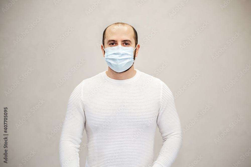Portrait of a young man with a mask on his mouth. White background. Portrait of a young man with a mask on his mouth. White background.