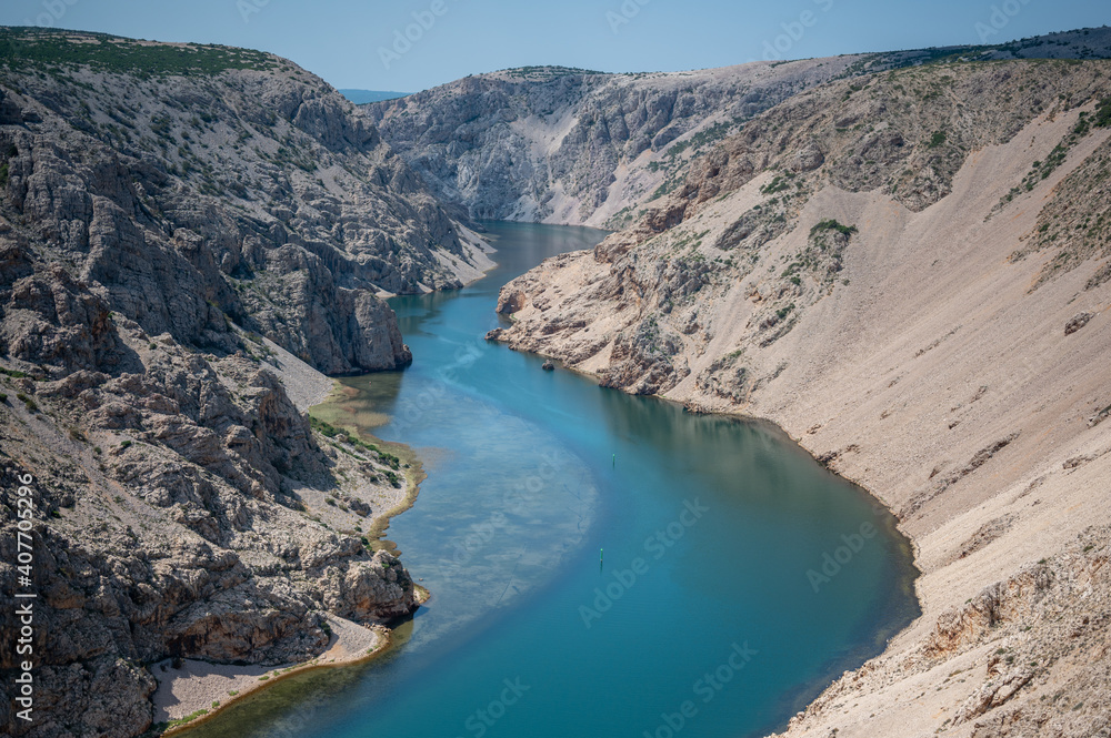 Woman enjoy the view - top of a mountain in Croatia - Landscape with blue river Woman enjoy the view - top of a mountain in Croatia - Landscape with blue river