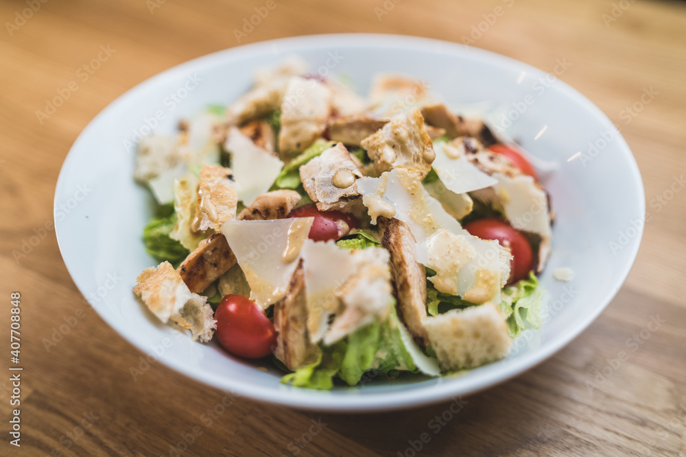 Close up of Caesar salad with croutons, cherry tomatoes and grilled chicken Close up of Caesar salad with croutons, cherry tomatoes and grilled chicken