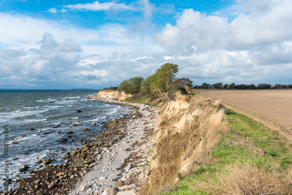 Hiking along the steep coast in the southeast towards the lighthouse on the Baltic Sea island of Fehmarn