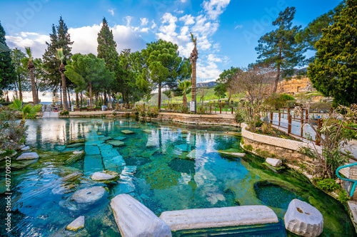 The Antique pool (Cleopatra's Bath) view in Pamukkale. It's a popular touristic destination during a Pamukkale visit photo