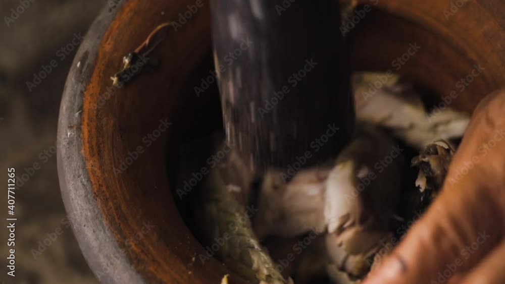 Someone crushing fish meat with mortar and pestle. Preparing to make a fish paste. Thai food menu. Someone crushing fish meat with mortar and pestle. Preparing to make a fish paste. Thai food menu.