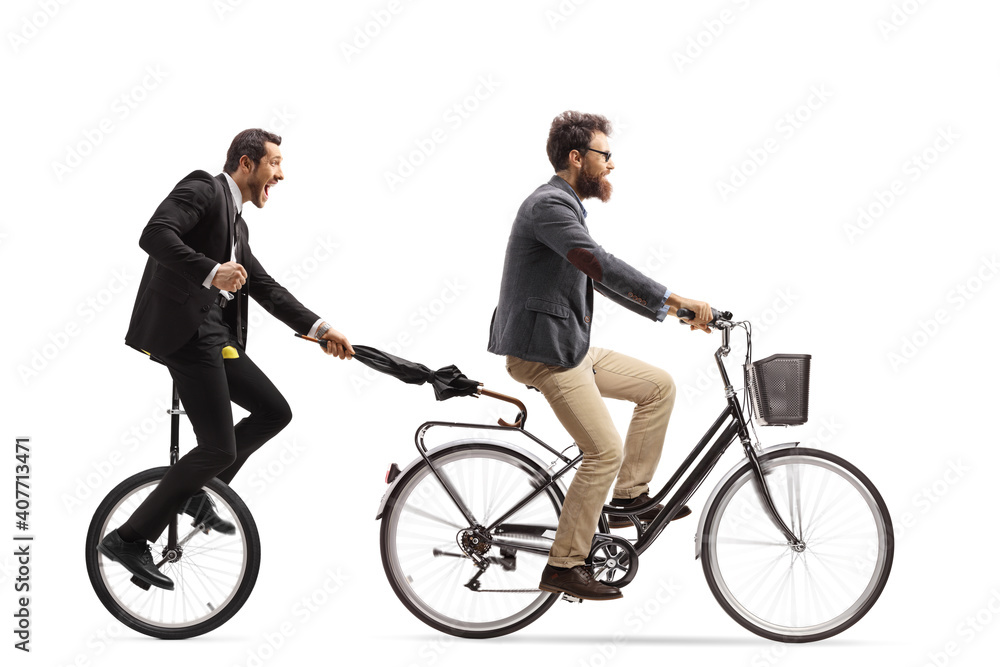 Man riding a unicycle and holding an umbrella behind a man with a bicycle Man riding a unicycle and holding an umbrella behind a man with a bicycle