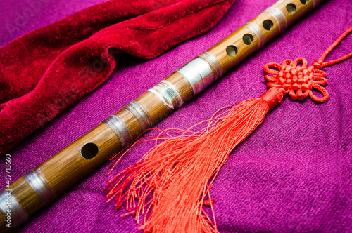 Chinese bamboo dizi flute with decoration and case. photo