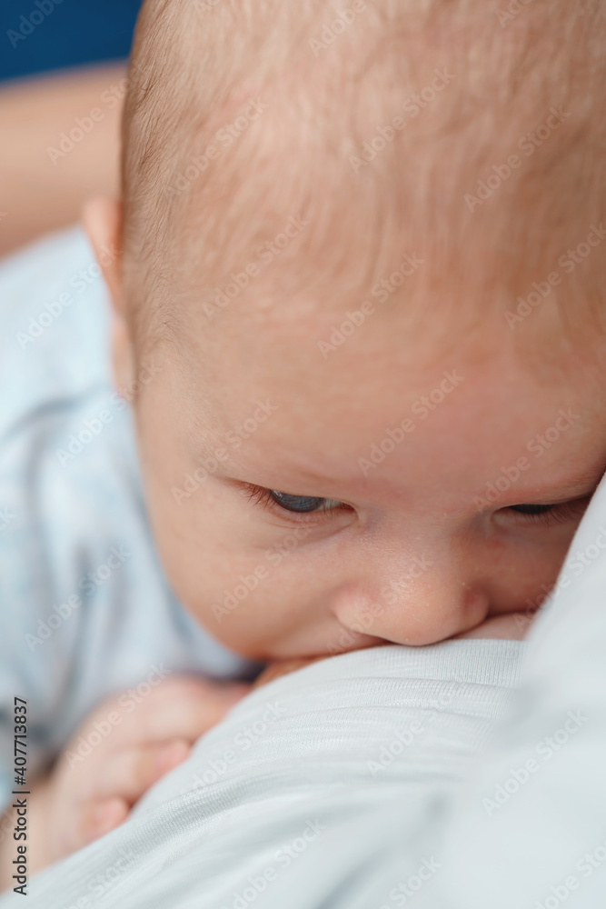 Close-up portrait of a child sucking milk from its mother's breast. Close-up portrait of a child sucking milk from its mother's breast.